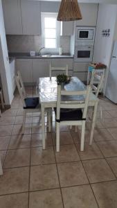 a table and chairs in a kitchen with a table and a table and a kitchen at Apartamentos Burgao in Caleta de Sebo