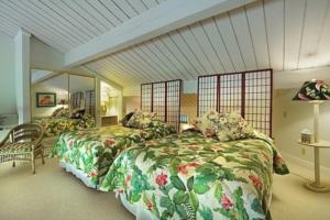 a bedroom with two beds and a mirror at Hanalei Bay Resort 7302 in Princeville