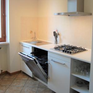 a kitchen with a stove and a sink at Corte Mantovani - Appartamenti in Colà di Lazise