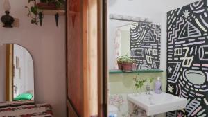 a bathroom with a sink and a mirror at Mi Casa es Tu Casa - Shkodra Backpackers Hostel in Shkodër