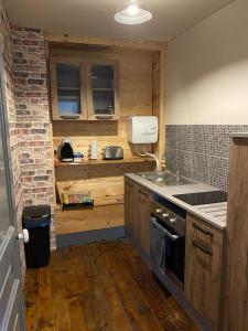a kitchen with a sink and a stove top oven at Tour du Château de Gondole in Le Cendre