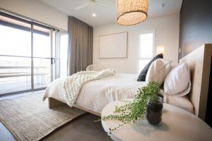 a bedroom with a bed and a table and a window at Lefties @ The Bay, Gracetown, Margaret River - NEW in Gracetown