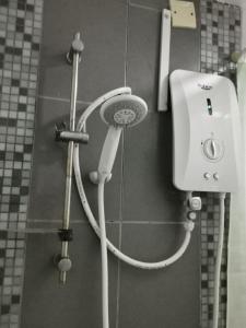 a shower in a bathroom with a shower head at Honrosa Studio at KBCC Service Apartment -with unifi in Kota Bharu