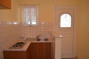 a small kitchen with a sink and a window at Hotel Loula Rooms and Apartments in Kamena Vourla +36 photos