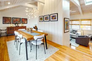 a dining room and living room with a table and chairs at Penthouse on Commercial in Provincetown