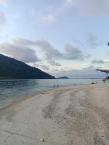 a view of a beach with people in the water at Suhaila Palace in Perhentian Islands