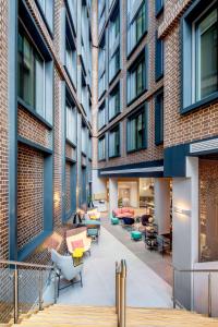 an internal courtyard of a building with tables and chairs at YOTEL London City in London