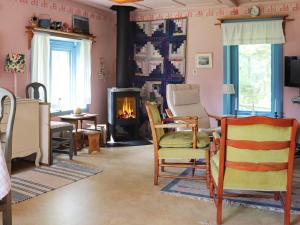 a living room with chairs and a fireplace at 6 person holiday home in STRA NTERVIK in Östra Ämtervik