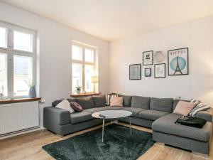 een woonkamer met een bank en een tafel bij 16 person holiday home in Rudk bing in Rudkøbing