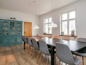 een eetkamer met een tafel en stoelen bij 16 person holiday home in Rudk bing in Rudkøbing