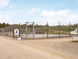 a chain link fence with a basketball hoop at 4 person holiday home in Rømø-By Traum in Sønderby