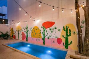 a room with a painting on the wall with a pool at Great Villas estudios - El Mexicano in Playa del Carmen