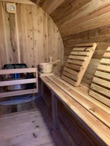 a wooden sauna with a bench and a bed at Snowman Lodge and Spa in Ohakune