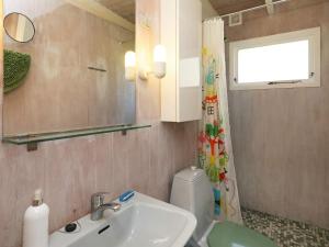 a bathroom with a sink and a toilet and a window at 6 person holiday home in Stege in Stege