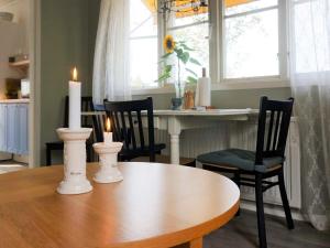 a dining room table with two candles on top of it at 4 person holiday home in UNDEN S in Undenäs