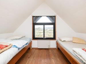 two beds in a room with a window at 6 person holiday home in Pandrup in Rødhus