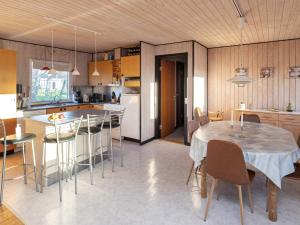 a kitchen and dining room with a table and chairs at 6 person holiday home in V ggerl se in Marielyst