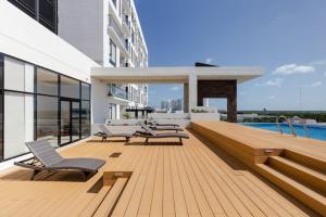 una terraza con sillas y una piscina en un edificio en San Francisco by Andiani Travel en Cancún