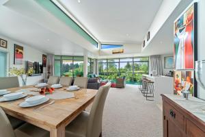 a dining room with a wooden table and chairs at Two Views Taupo Apartment in Taupo