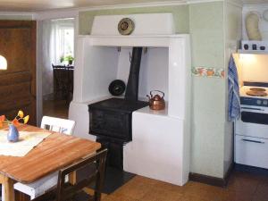 een keuken met een houtkachel in een kamer bij 5 person holiday home in LAMMHULT in Lammhult