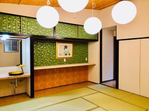 a room with a mirror and a counter and lights at Art House in Osaka