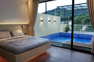 una camera da letto con un letto e una piscina di villa view2 sayriah a Puncak