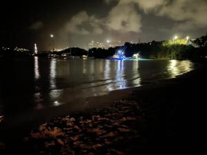 a view of a river at night with lights at Virgin Islands Campground in Water Island