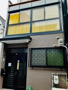 a building with a large window on the side of it at Yumeji Guest House in Osaka