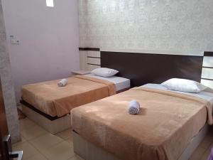 Voodi või voodid majutusasutuse Trivadoh Syariah Hotel toas