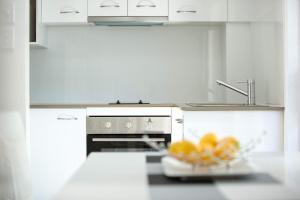 a kitchen counter with a bowl of fruit on top of it at Byron Central Apartments in Byron Bay