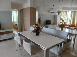 a kitchen and living room with a white table and chairs at Batavia apartemen in Jakarta