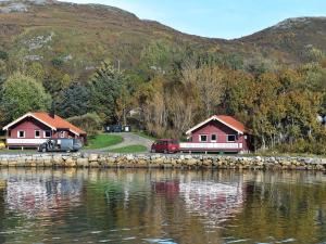 a couple of houses next to a body of water at 6 person holiday home in Bud in Bud