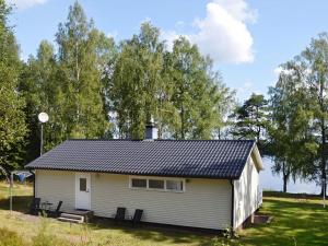 a white house with a solar roof on a field at 4 person holiday home in GISLAVED in Gislaved