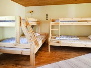 two bunk beds in a room with wooden floors at 6 person holiday home in Br landa in Brålanda