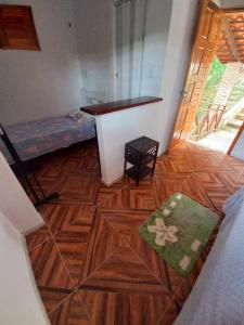 a small room with a bed and a table in it at CASINHA DA SERRA in Baturité