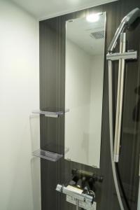 a bathroom with a mirror and a sink at Liaison Court Nishikujo Universal Bay in Osaka +49 photos