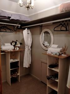 a dressing room with shelves and a mirror at Amberly House Rotorua in Rotorua