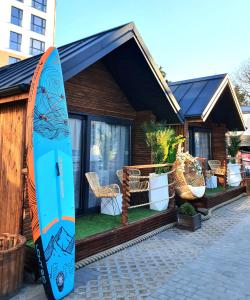 a surfboard is standing next to a house at Villa Promenada in Międzyzdroje