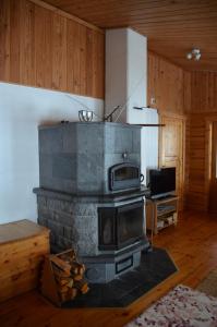 a fireplace in a living room with a stove at Turjanlinna in Rantasalmi