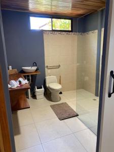 a bathroom with a shower and a toilet and a sink at MâpleTico Casita in Monteverde Costa Rica