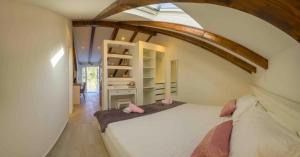 a bedroom with a large white bed in a room at Apartments Filip - vineyard and large terrace in Vis