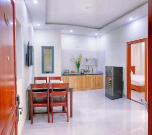 a living room with a table and a kitchen at Tiến Đạt Apartment in Nha Trang