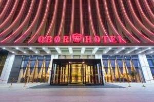 a building with a sign on the front of it at OBOR Hotel in Ürümqi