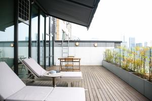 a balcony with chairs and a table on a building at Hotel Crescendo Seoul in Seoul