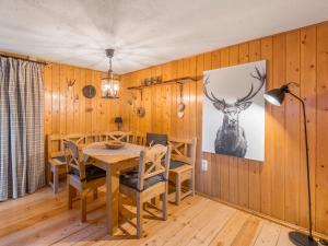 a dining room with a table and a deer on the wall at Holiday home on the mountain with views in Ballenstedt