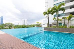 a swimming pool in front of a building at Seaview condo near RF Mall, Food Court & Free Netflix in Johor Bahru