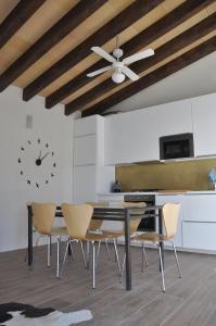 a kitchen with a table and chairs and a clock on the wall at Ca'n Guiri, Eco Finca in Mallorca in Campanet