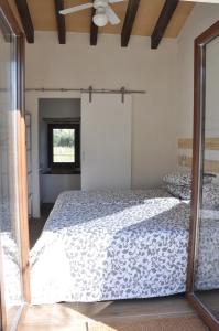 a bedroom with a bed and a mirror at Ca'n Guiri, Eco Finca in Mallorca in Campanet