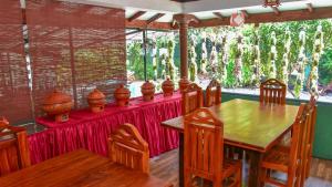 a dining room with a table with a red table cloth at The King's Garden Resort in Dambulla