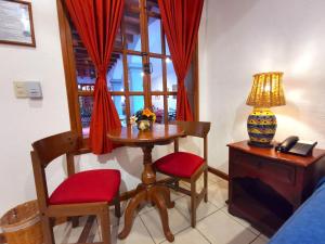 a room with a table and chairs and a window at Hotel Casa de la Tía Tere in Oaxaca City +47 photos